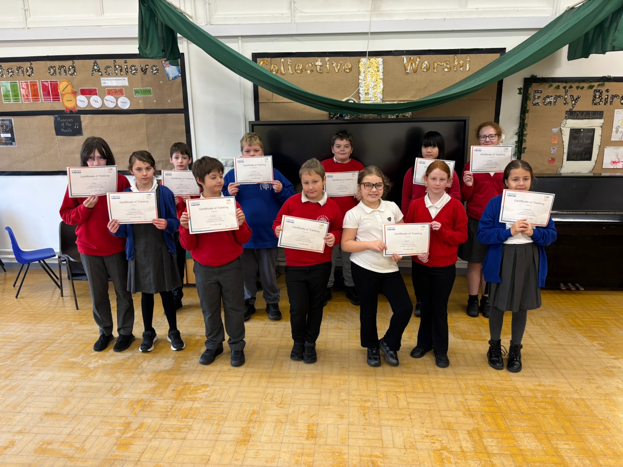A group of children smiling holding certificates.